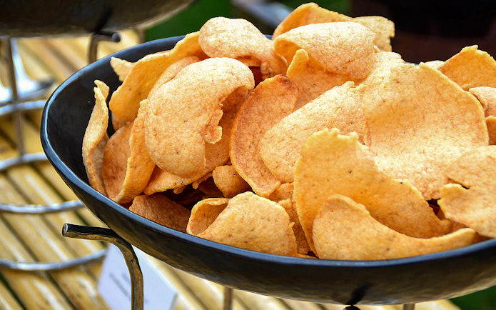 Crispy prawn crackers in a bowl at SkyFeast, Sydney Tower dining experience.