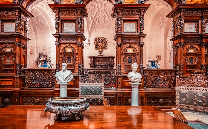 Busts and ornate woodwork in the Hall of Honor, Peles Castle, Romania.