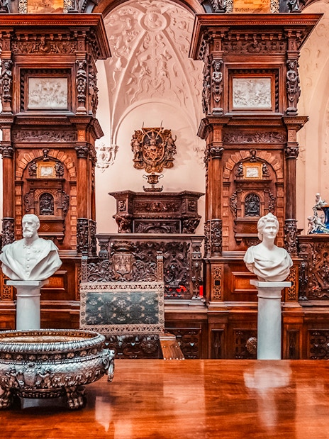 Busts and ornate woodwork in the Hall of Honor, Peles Castle, Romania.
