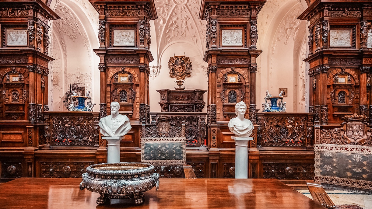 Busts and ornate woodwork in the Hall of Honor, Peles Castle, Romania.