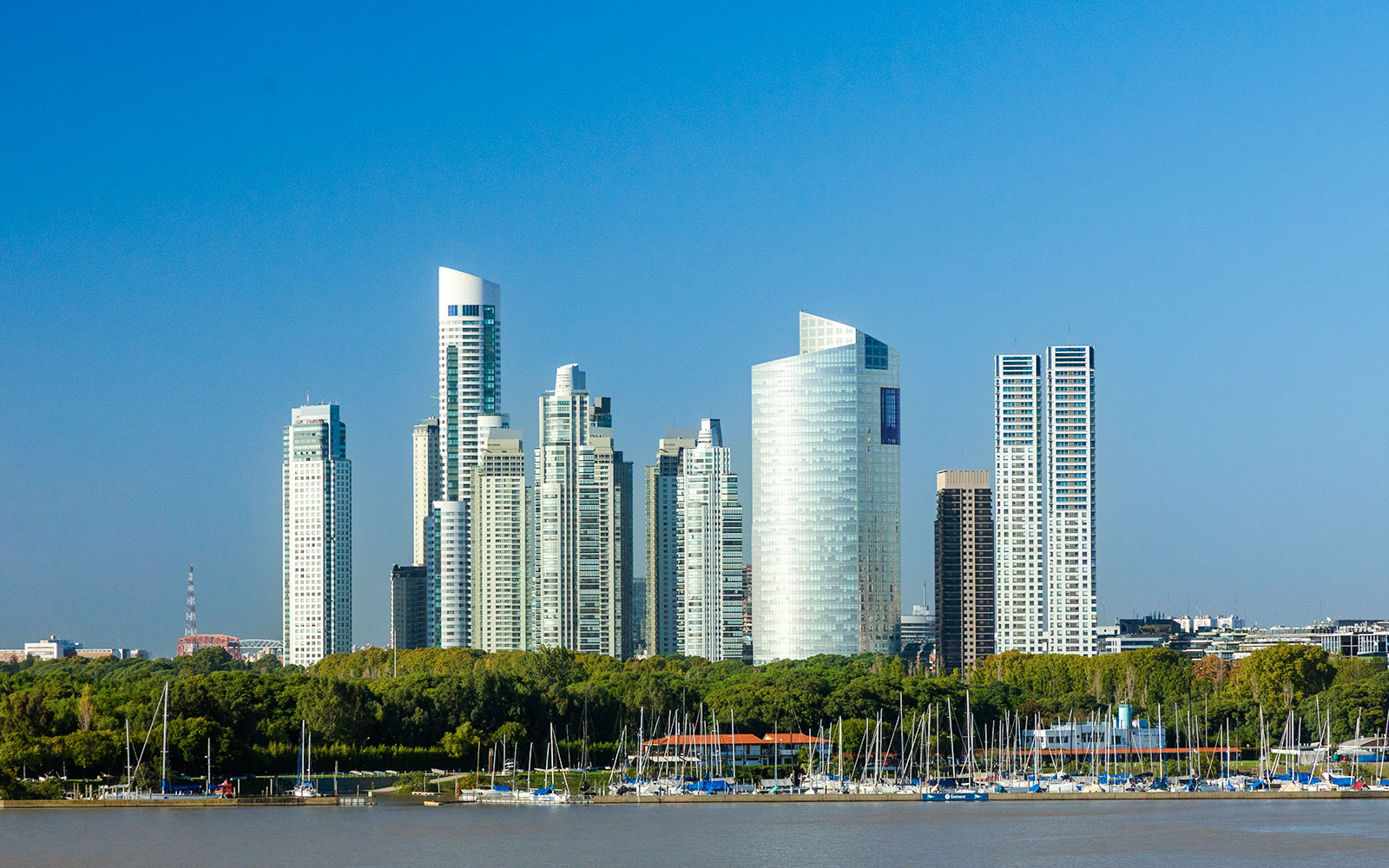 Puerto Madero skyline with modern skyscrapers and yachts in Buenos Aires harbor.