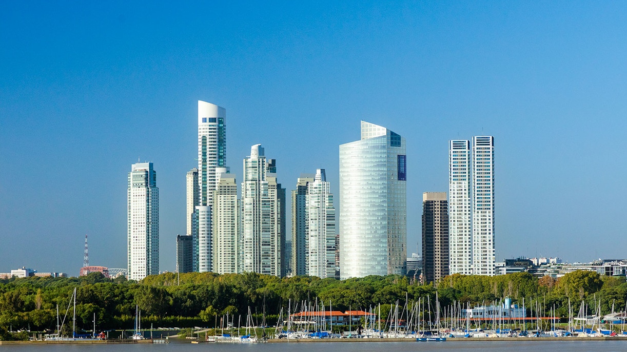 Puerto Madero skyline with modern skyscrapers and yachts in Buenos Aires harbor.