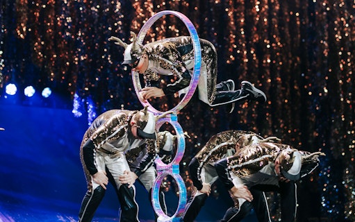 Acrobats performing through hoops in Cirque du Soleil 'Twas The Night Before show.