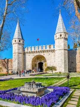 Topkapi Palace courtyard with historic gate and gardens in Istanbul, Turkey.
