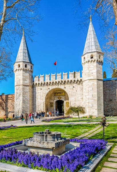 Topkapi Palace courtyard with historic gate and gardens in Istanbul, Turkey.