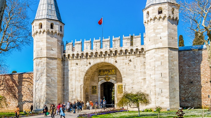 Topkapi Palace courtyard with historic gate and gardens in Istanbul, Turkey.