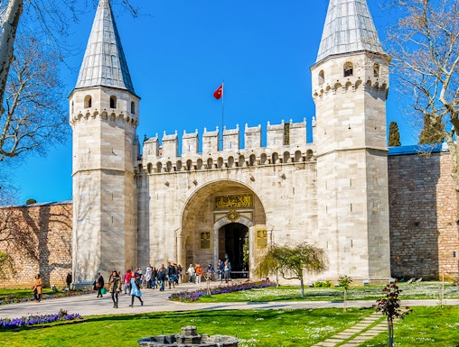 Topkapi Palace courtyard with historic gate and gardens in Istanbul, Turkey.