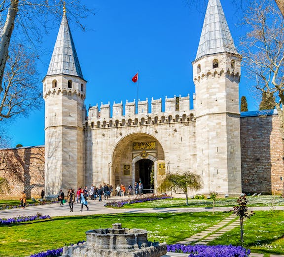 Topkapi Palace courtyard with historic gate and gardens in Istanbul, Turkey.