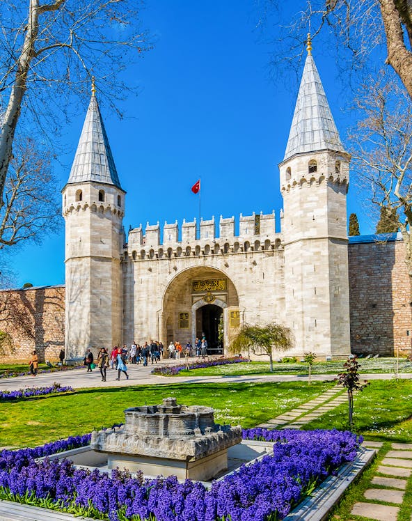 Topkapi Palace courtyard with historic gate and gardens in Istanbul, Turkey.