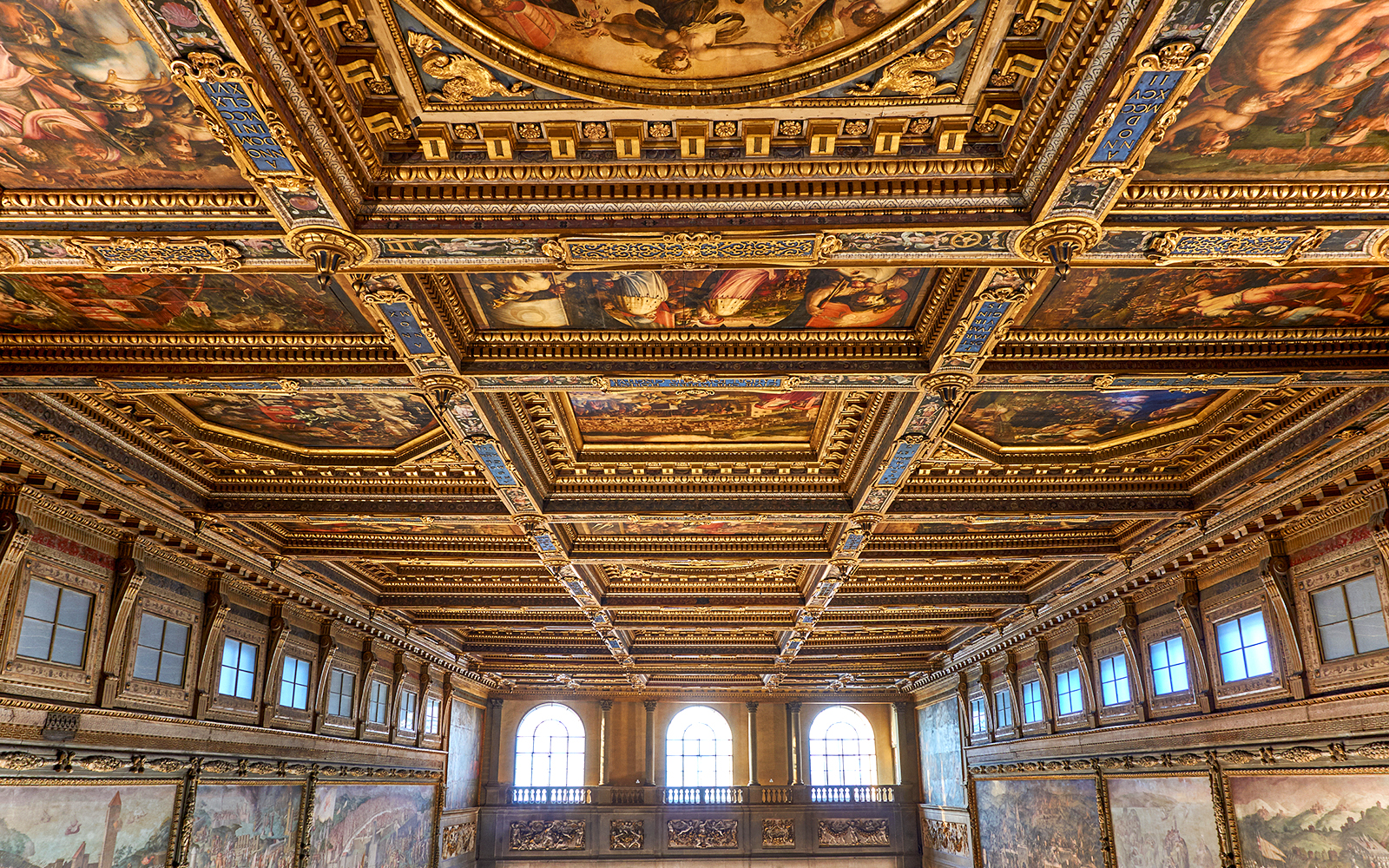 Palazzo Vecchio corridor ceiling with ornate frescoes and gilded details in Florence, Italy.