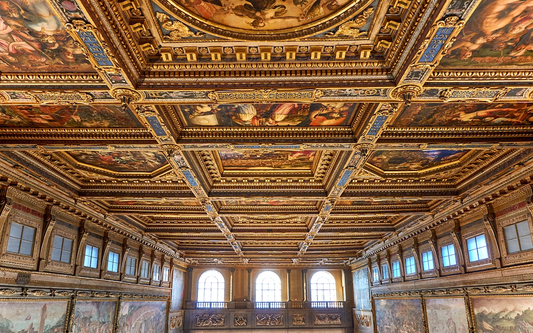 Palazzo Vecchio corridor ceiling with ornate frescoes and gilded details in Florence, Italy.