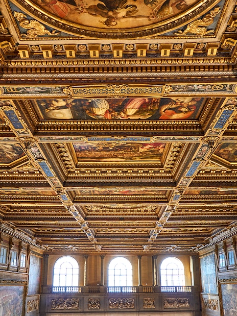 Palazzo Vecchio corridor ceiling with ornate frescoes and gilded details in Florence, Italy.
