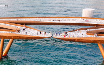 Visitors walking on Kiss Bridge over the ocean during Phu Quoc Sunset Tour.