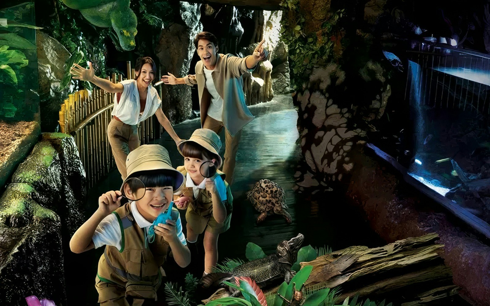Tourists exploring aquatic exhibits at Sea Life Bangkok with children observing wildlife.