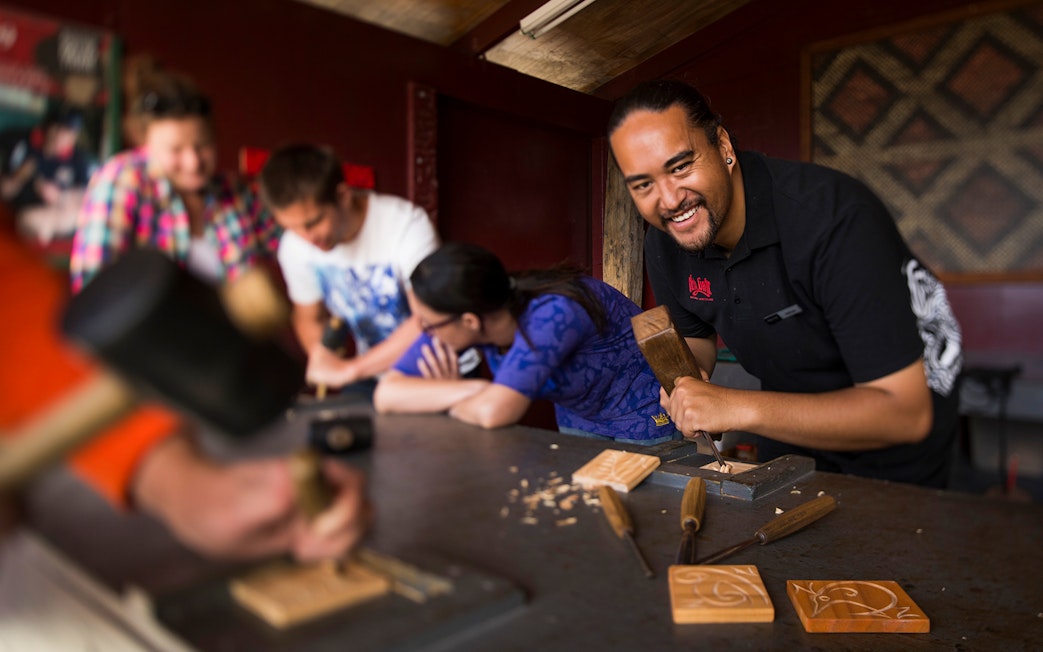 Maori carving workshop at Hells Gate Geothermal Walk, participants learning traditional techniques.