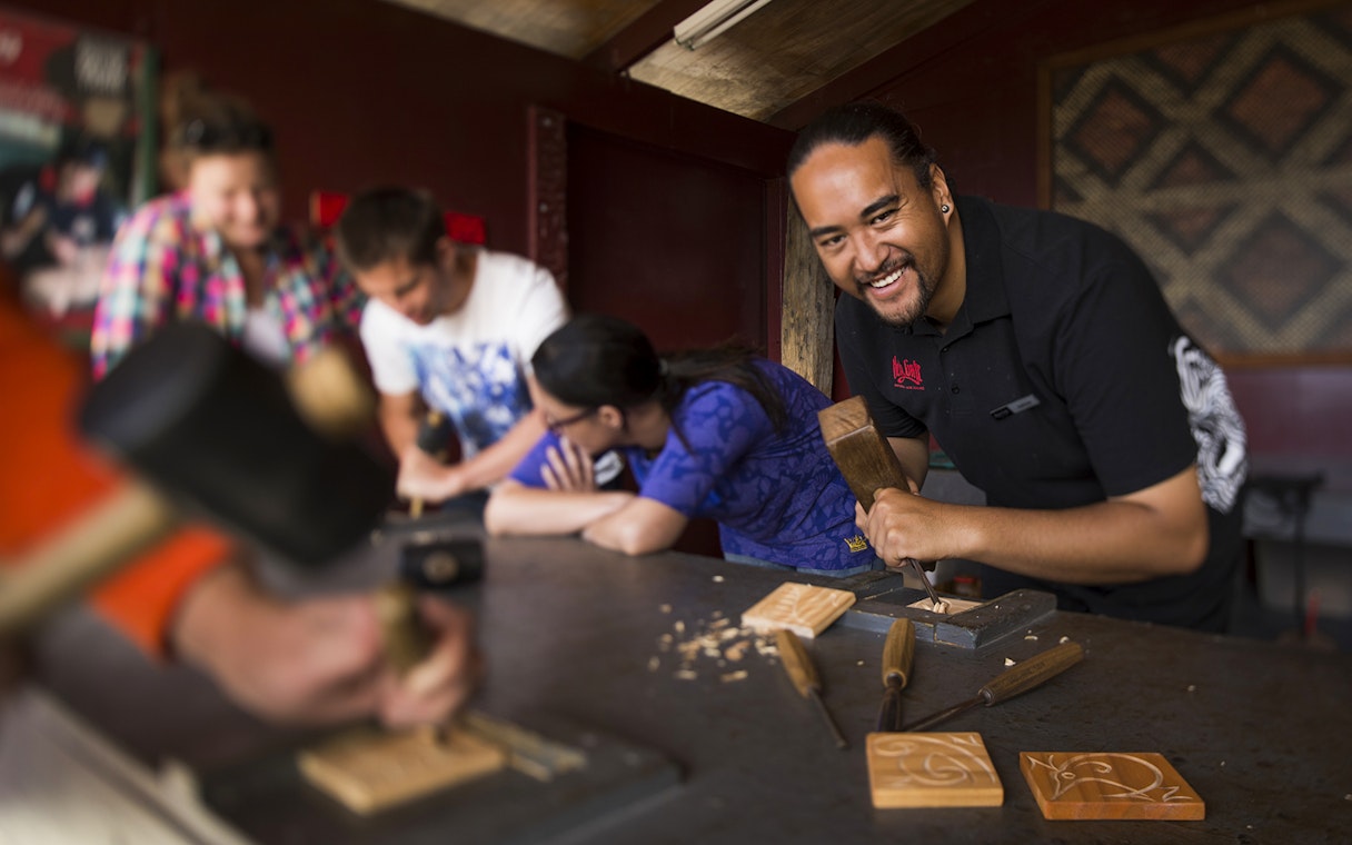 Maori carving workshop at Hells Gate Geothermal Walk, participants learning traditional techniques.