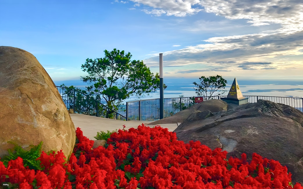 Sun World Ba Den Mountain summit view with red flowers and distant landscape.