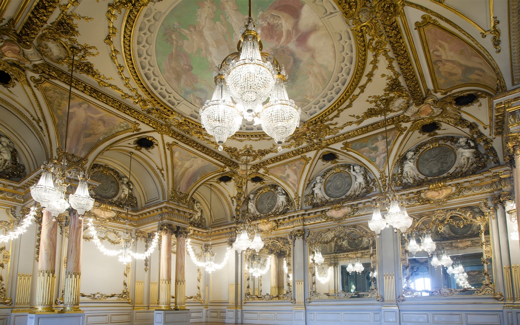 Ornate ballroom with chandeliers and frescoes at Orsay Museum, Paris.