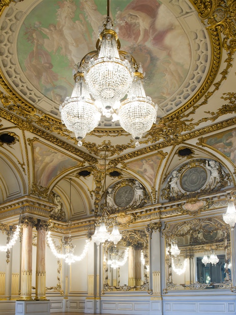 Ornate ballroom with chandeliers and frescoes at Orsay Museum, Paris.