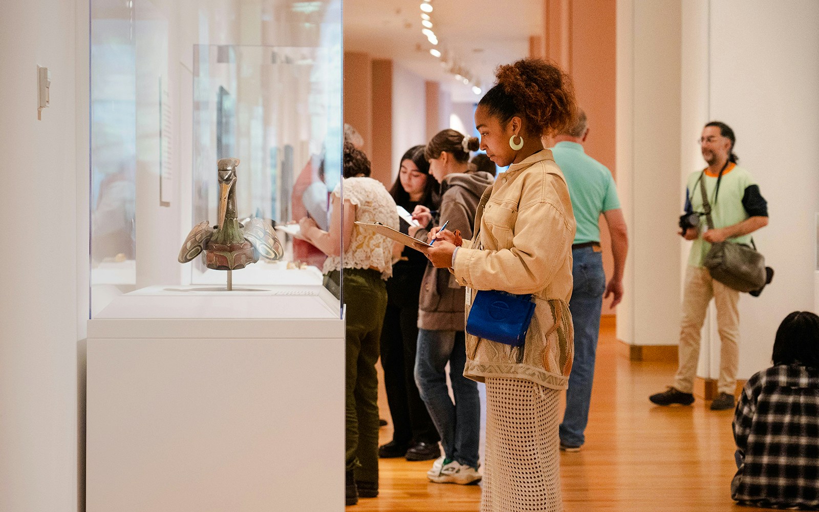 Visitors observing an exhibit at the Seattle Art Museum.