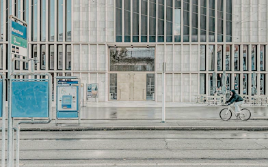 Kunsthaus Zurich exterior with cyclist and tram stop in foreground.