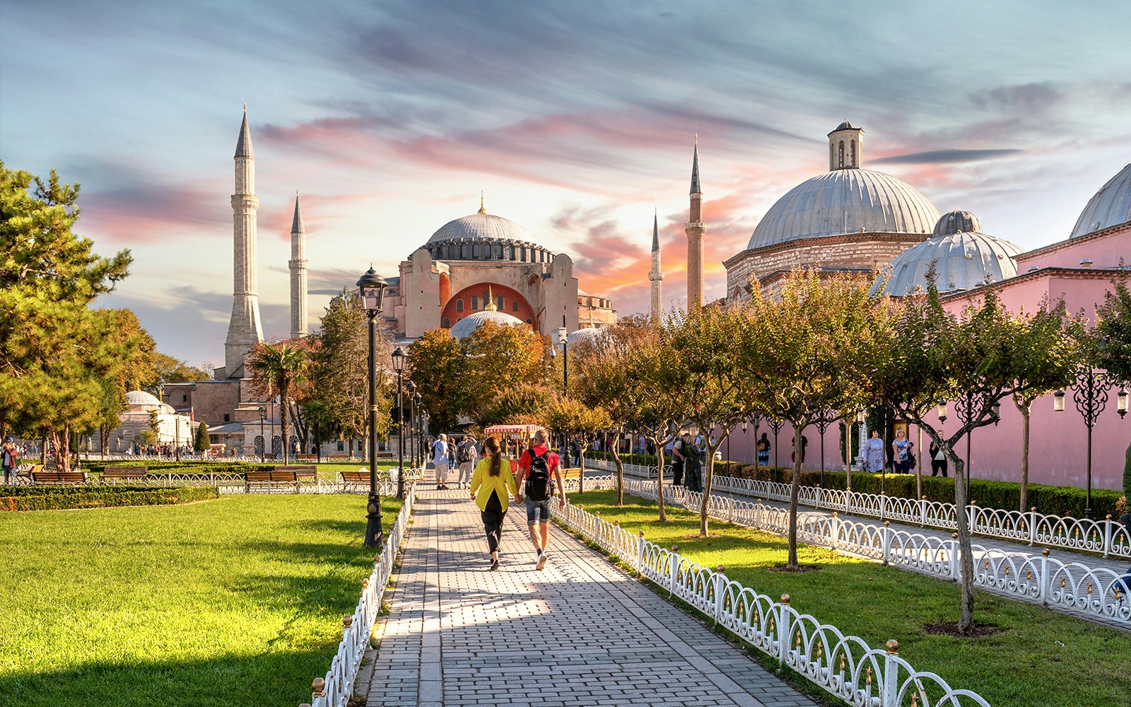 Hagia Sophia exterior with visitors walking in the garden, Istanbul.