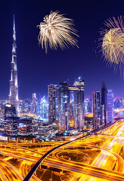 Downtown Dubai skyline with illuminated skyscrapers and fireworks at night, United Arab Emirates.