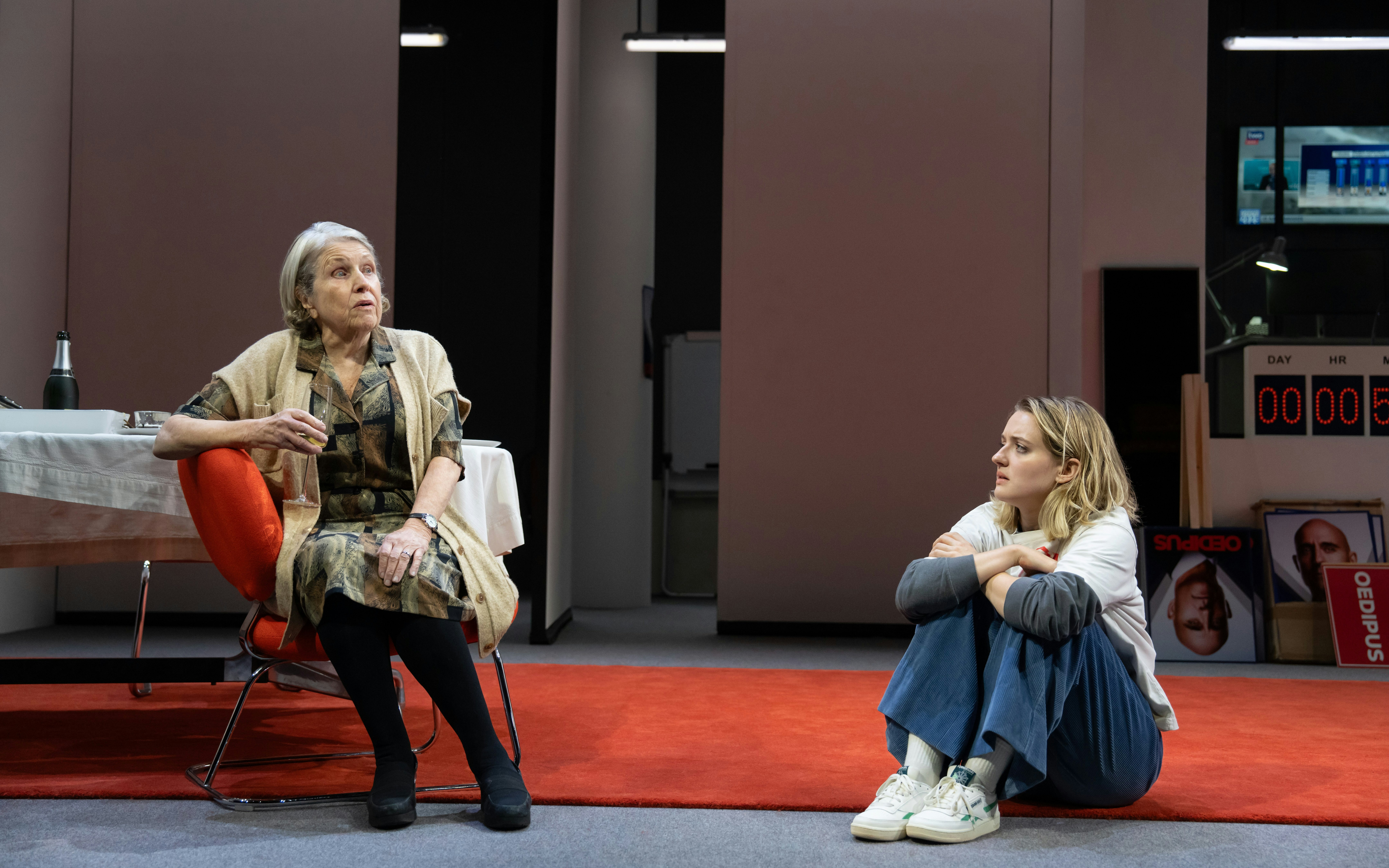 Elderly woman and young woman in conversation on stage at Oedipus Broadway show.