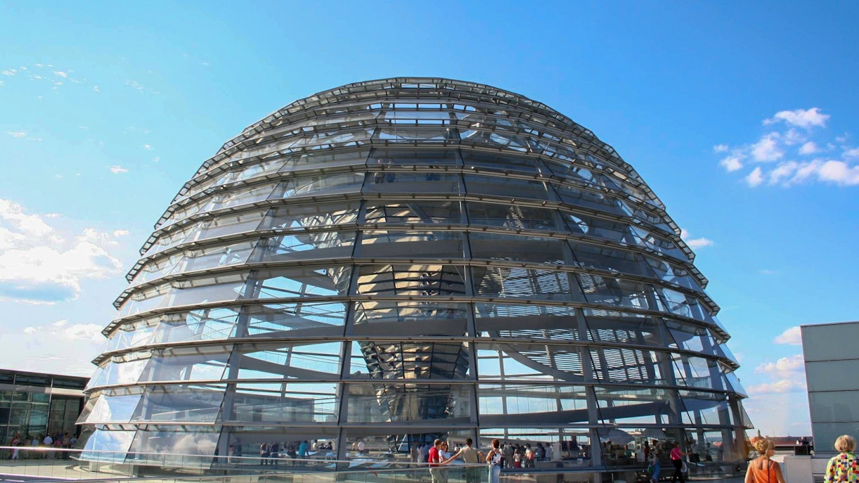 Reichstag dome in Berlin with visitors on the rooftop terrace.