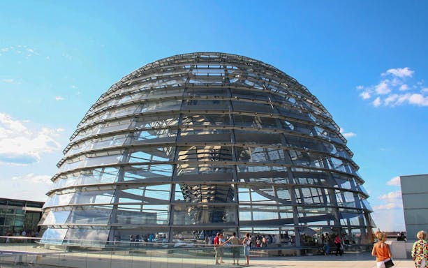 Reichstag dome in Berlin with visitors on the rooftop terrace.