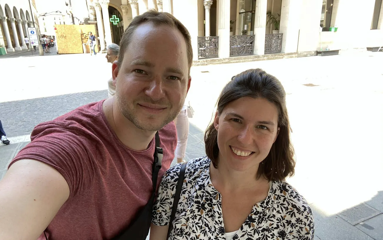 Selfie of two people in front of historic architecture in Padua during a city exploration game.