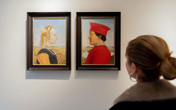 Visitor viewing Renaissance portraits at an Amsterdam museum.