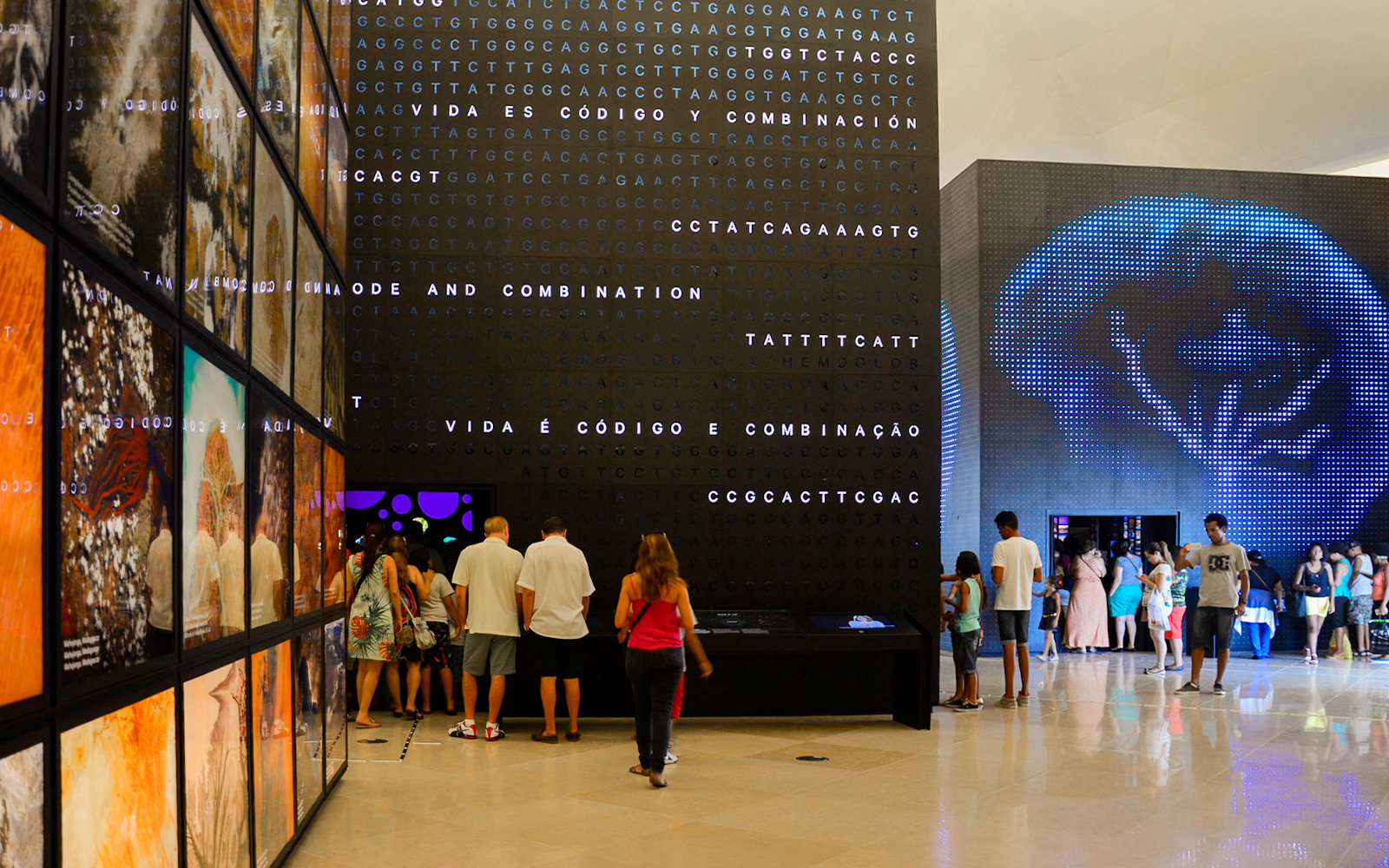 Tourists exploring interactive displays inside Aquário Aquarium.