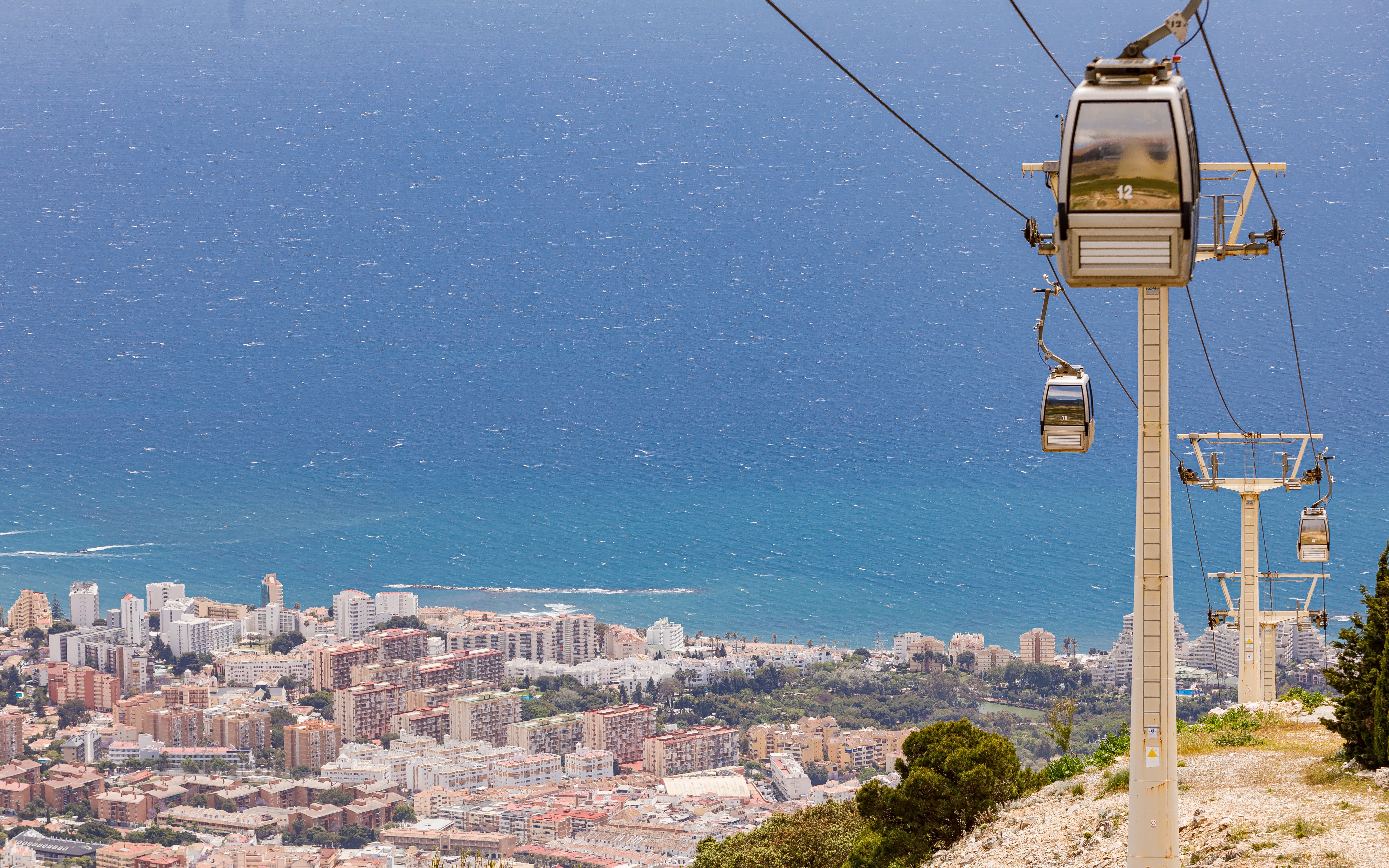 Benalmádena cable car overlooking cityscape and Mediterranean Sea.