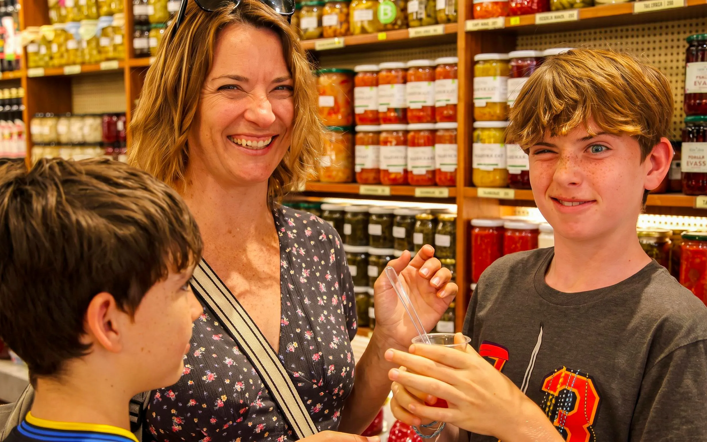 Family enjoying a tasting at a local market during an Istanbul food tour.