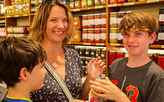 Family enjoying a tasting at a local market during an Istanbul food tour.