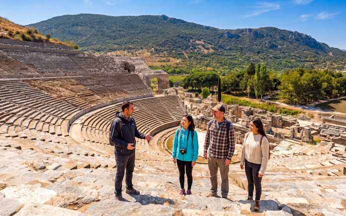 Tour group exploring the ancient amphitheater in Ephesus, Turkey.