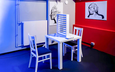 Interactive exhibit at DeJa Vu Museum Berlin with chairs and abstract art.