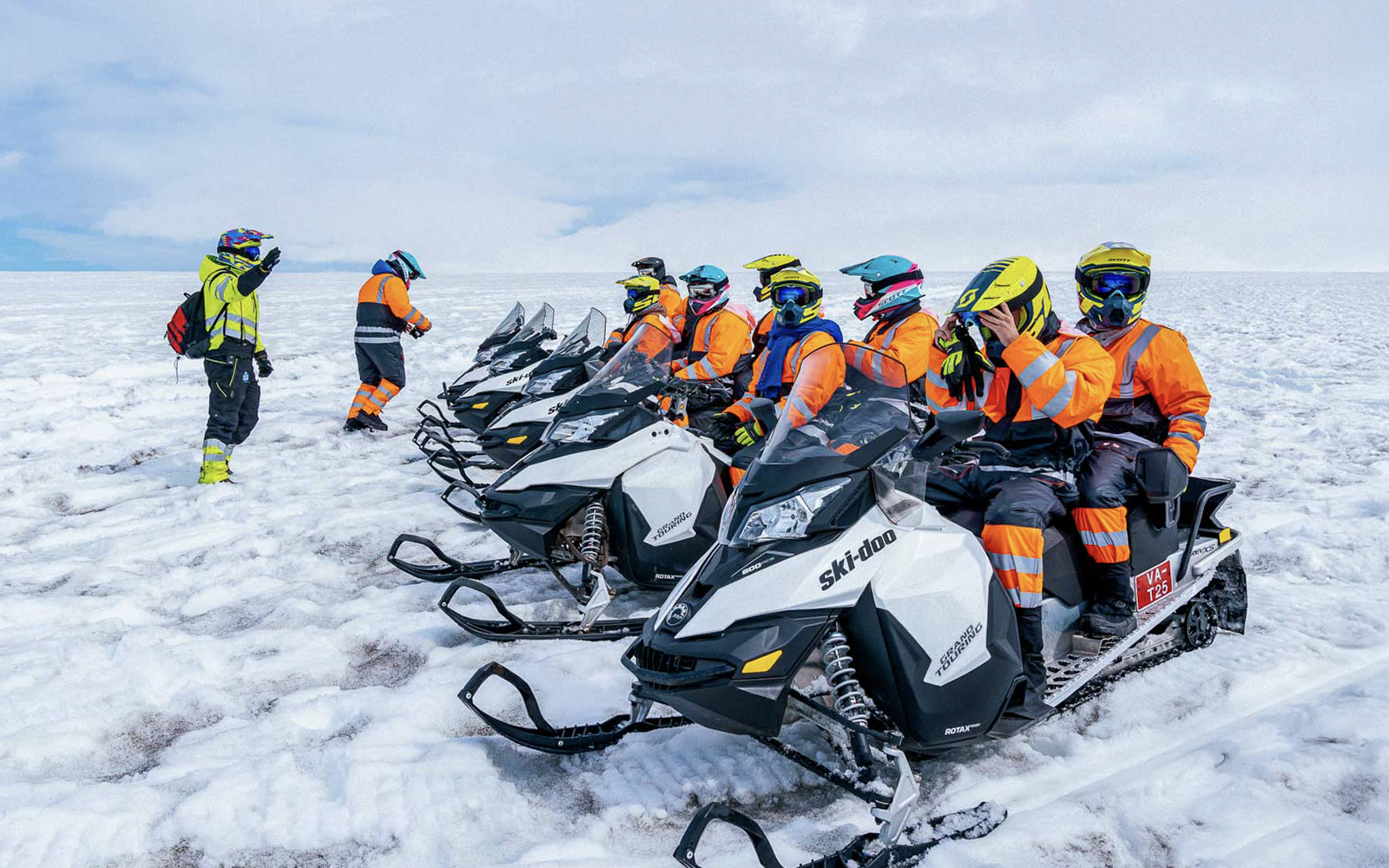 Snowmobile riders preparing for a tour on Langjökull glacier.