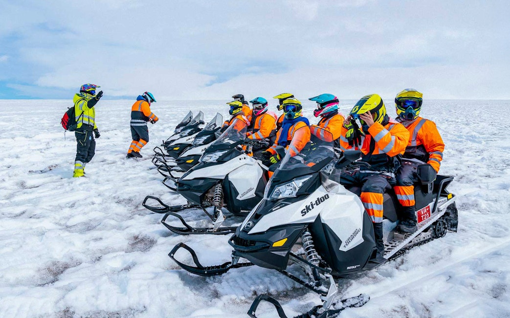Snowmobile riders preparing for a tour on Langjökull glacier.