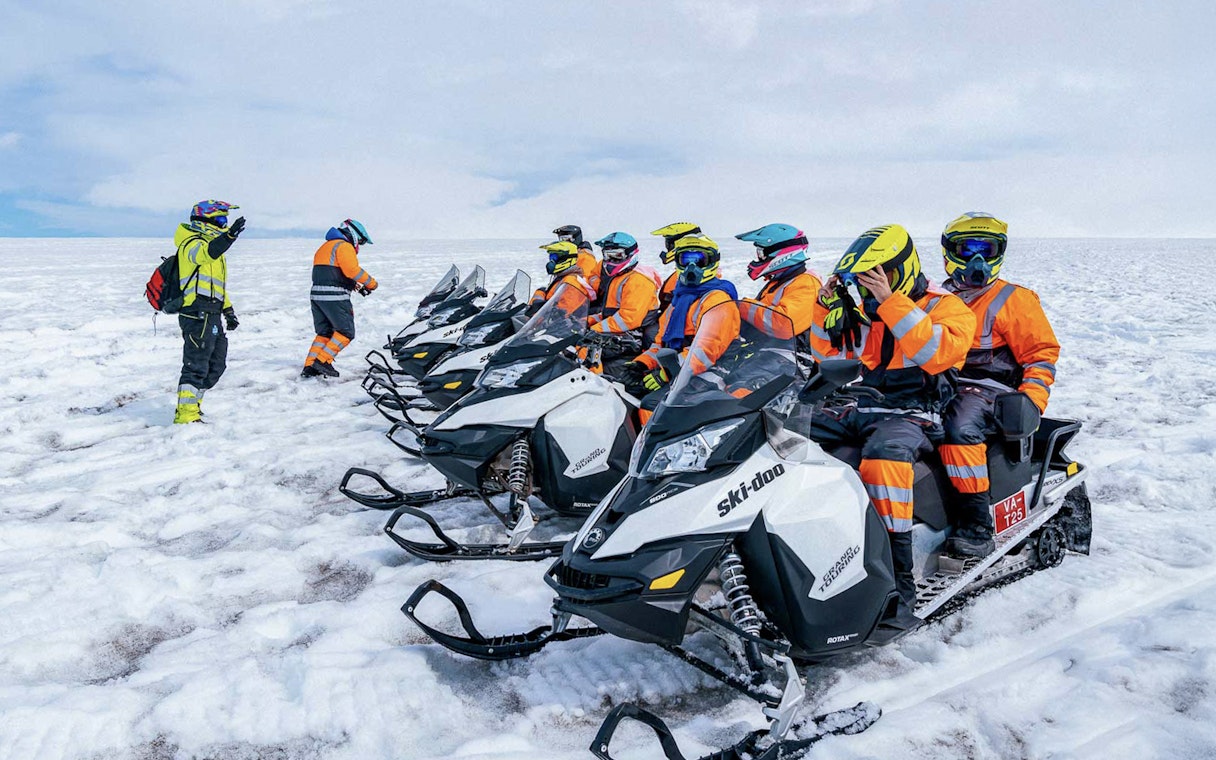 Snowmobile riders preparing for a tour on Langjökull glacier.