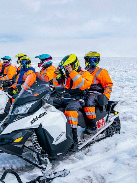 Snowmobile riders preparing for a tour on Langjökull glacier.