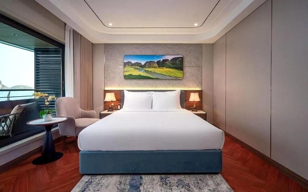 Luxury cabin interior on Calista Ocean cruise, Ha Long Bay, with ocean view and elegant decor.