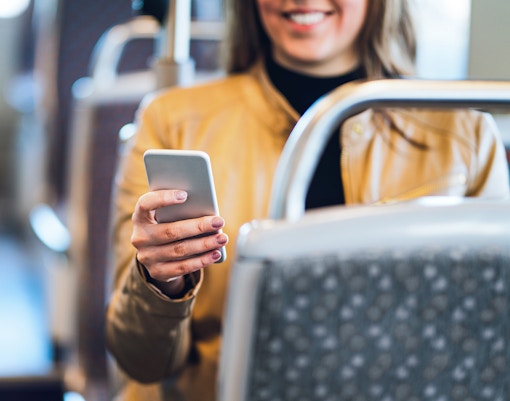 Tourist using wifi on Hop-on hop-off bus Oslo, Norway.