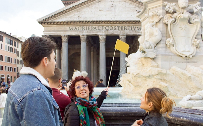 Tour guide leading a group at the Pantheon in Rome.