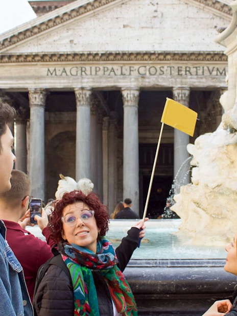 Tour guide leading a group at the Pantheon in Rome.