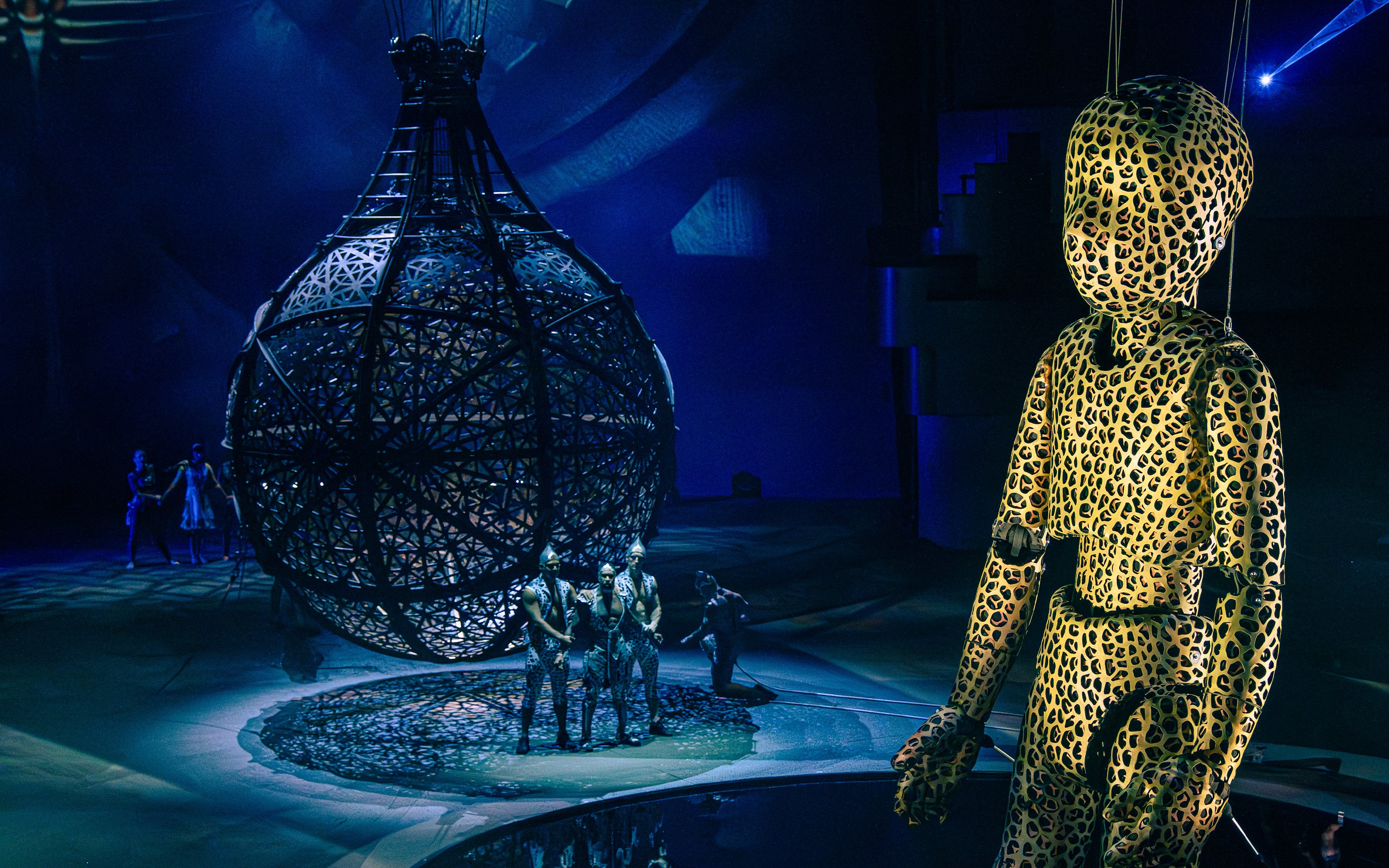 Puppet in leopard print near Globe of Death at La Perle performance.