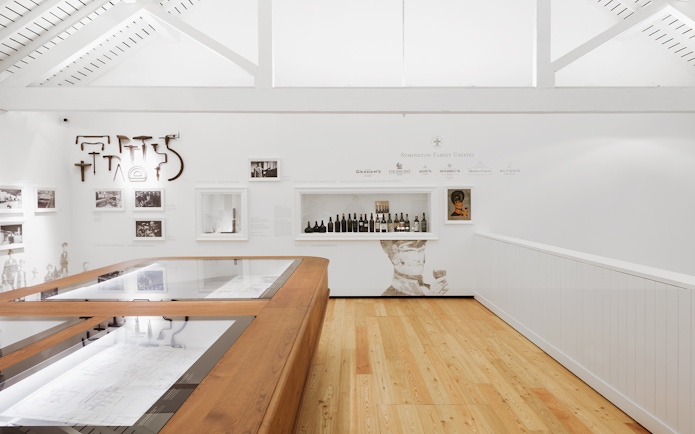 Graham’s Port Lodge interior with wine display and historical exhibits.