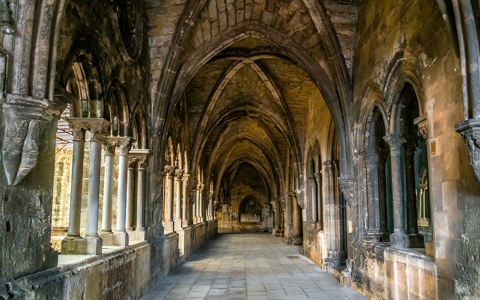 St Mary Major Cathedral cloisters in Lisbon with arched walkways and historic architecture.