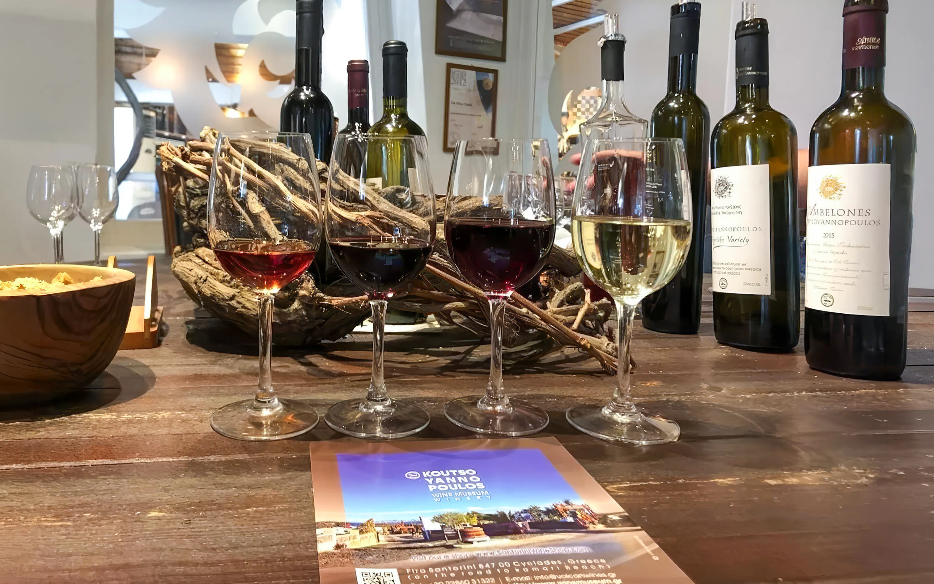 Wine tasting setup with glasses and bottles on a Santorini Sunset Wine Tour.